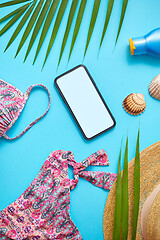 Image showing Women beach summer clothes and accessories collage on blue backg