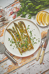 Image showing Roasted asparagus with parmesan cheese and parsley. Healthy spri