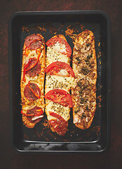 Image showing Delicious hot sandwich baguettes baked with tuna, cheese, tomato