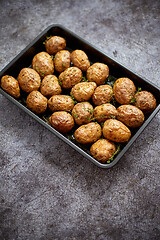 Image showing Homemade roasted whole potatoes in jackets. With butter, rosemar