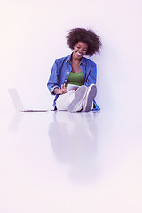 Image showing african american woman sitting on floor with laptop