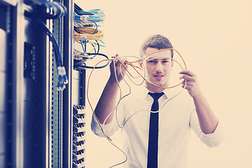 Image showing young it engeneer in datacenter server room