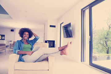 Image showing african american woman at home with digital tablet