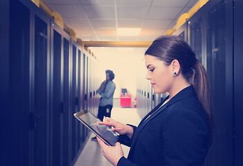 Image showing Female engineer working on a tablet computer in server room