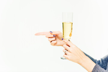 Image showing Celebration. Female hands holding the glasse of champagne or wine making a toast.