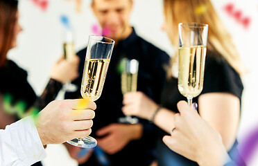 Image showing Celebration. Hands holding the glasses of champagne and wine making a toast.