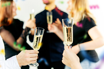 Image showing Celebration. Hands holding the glasses of champagne and wine making a toast.