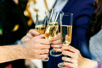 Image showing Celebration. Hands holding the glasses of champagne and wine making a toast.