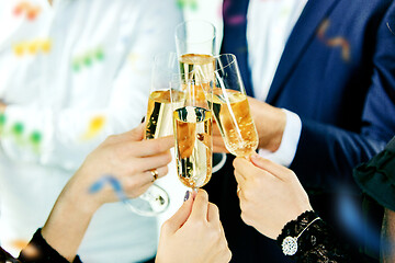 Image showing Celebration. Hands holding the glasses of champagne and wine making a toast.