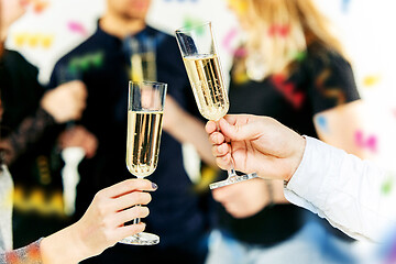 Image showing Celebration. Hands holding the glasses of champagne and wine making a toast.