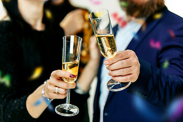 Image showing Celebration. Hands holding the glasses of champagne and wine making a toast.