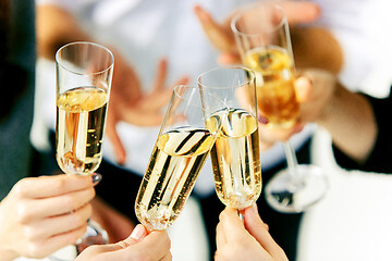 Image showing Celebration. Hands holding the glasses of champagne and wine making a toast.