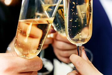 Image showing Celebration. Hands holding the glasses of champagne and wine making a toast.