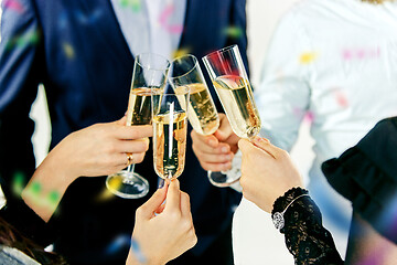 Image showing Celebration. Hands holding the glasses of champagne and wine making a toast.