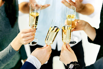 Image showing Celebration. Hands holding the glasses of champagne and wine making a toast.