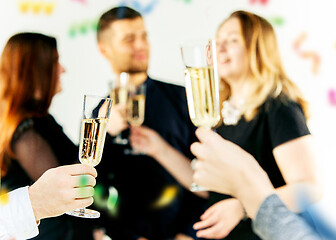 Image showing Celebration. Hands holding the glasses of champagne and wine making a toast.