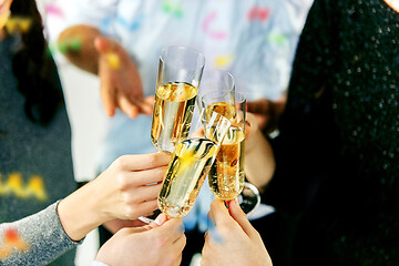 Image showing Celebration. Hands holding the glasses of champagne and wine making a toast.