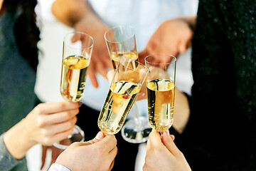 Image showing Celebration. Hands holding the glasses of champagne and wine making a toast.