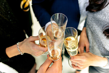 Image showing Celebration. Hands holding the glasses of champagne and wine making a toast.