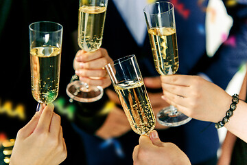 Image showing Celebration. Hands holding the glasses of champagne and wine making a toast.