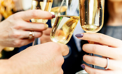 Image showing Celebration. Hands holding the glasses of champagne and wine making a toast.