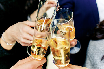 Image showing Celebration. Hands holding the glasses of champagne and wine making a toast.