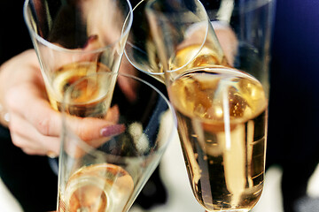 Image showing Celebration. Hands holding the glasses of champagne and wine making a toast.