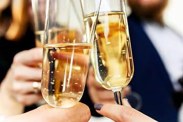 Image showing Celebration. Hands holding the glasses of champagne and wine making a toast.