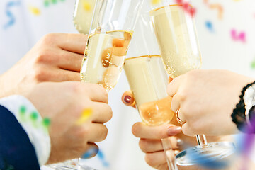 Image showing Celebration. Hands holding the glasses of champagne and wine making a toast.