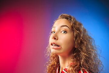Image showing Young woman with disgusted expression repulsing something