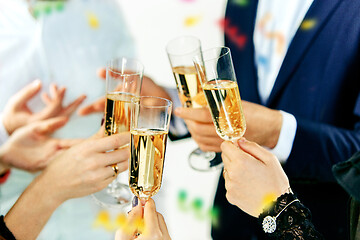 Image showing Celebration. Hands holding the glasses of champagne and wine making a toast.