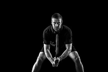 Image showing one caucasian man playing tennis player on black background