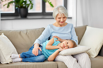 Image showing grandmother and granddaughter resting on pillow