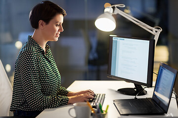 Image showing businesswoman working on laptop at night office