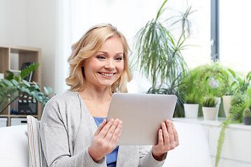 Image showing middle aged woman with tablet computer at home