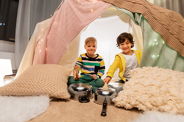 Image showing boys with pots playing music in kids tent at home