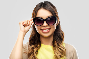 Image showing happy smiling young asian woman in sunglasses