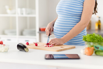 Image showing close up of pregnant woman cooking food at home