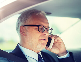 Image showing senior businessman calling on smartphone in car