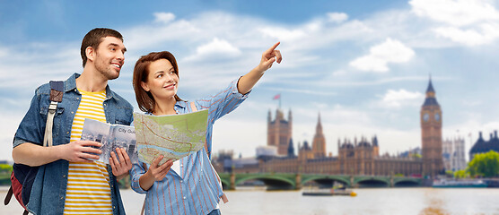 Image showing happy couple of tourists with city guide and map