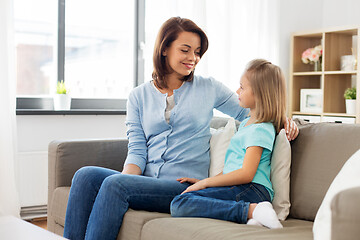 Image showing mother and daughter looking at each other at home