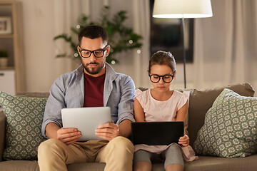 Image showing father and daughter with tablet computers at home