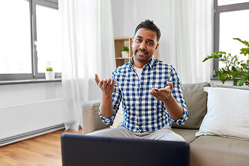 Image showing indian male blogger shrugging at home