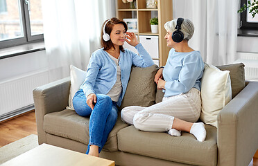 Image showing senior mother and adult daughter with headphones