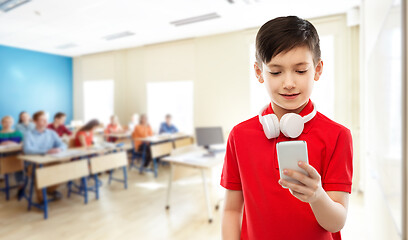 Image showing boy in red t-shirt with headphones and smartphone