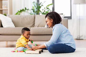 Image showing mother and baby playing with toy blocks at home