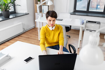 Image showing businesswoman with laptop working at office