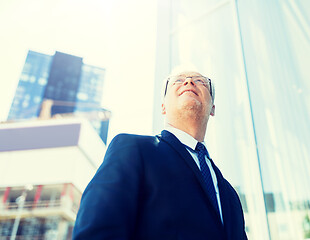 Image showing senior businessman on city street