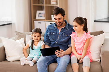 Image showing happy father and daughters with tablet pc at home