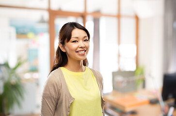 Image showing happy asian woman over office background